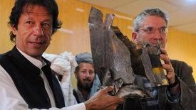 Imran Khan, left, and Clive Stafford Smith hold up part of a missile fired by a U.S. drone during a press conference in Islamabad, Oct. 27, 2011. 