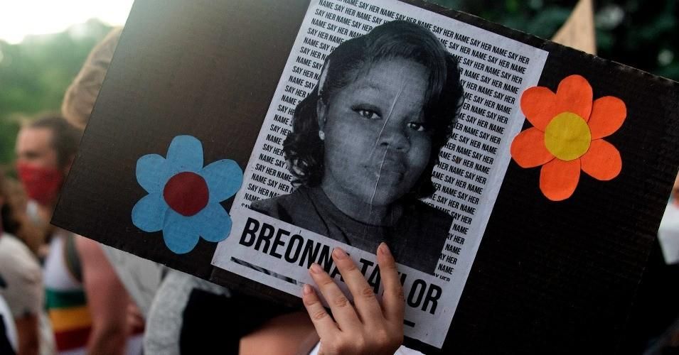 A demonstrator holds a sign with the image of Breonna Taylor, a black woman who was fatally shot by Louisville Metro Police Department officers, during a protest against racial injustice and the death George Floyd in Minneapolis, in Denver, Colorado on June 3, 2020. 