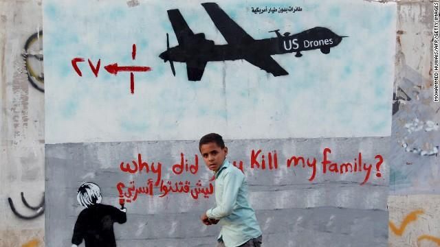 A child walks by a mural showing a U.S. drone in the Yemeni capital of Sanaa. (Photo: AFP/Getty Images)