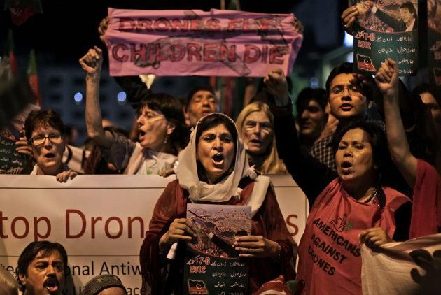 Pakistanis and American citizens hold banners and chant slogans against drone attacks in Pakistani tribal belt, in Islamabad, Pakistan, Friday, Oct. 5, 2012.