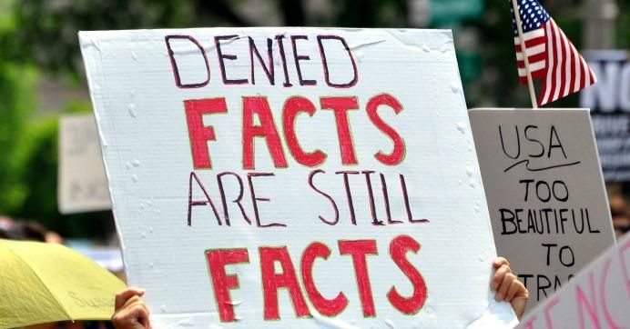 Climate march sign reads 'denied facts are still facts'