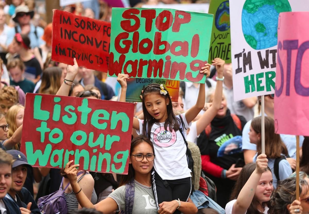 People hold up signs and vent their frustrations during a Climate Change Awareness rally at Sydney Town Hall on March 15, 2019 in Sydney, Australia. 