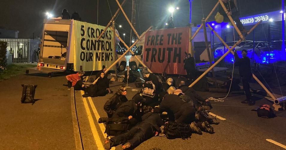 Amid banners that read, "5 Crooks Control Our News" and "Free the Truth," campaigners with Extinction Rebellion UK blocked delivery trucks belonging to Rupert Murdoch's News UK in the early morning of Saturday, Sept. 5, 2020. (Photo: @XRebellionUK)