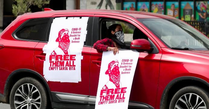 People take part in an Alliance for Boys and Men of Color car rally in downtown Oakland, Calif., on Thursday, April 16, 2020. 