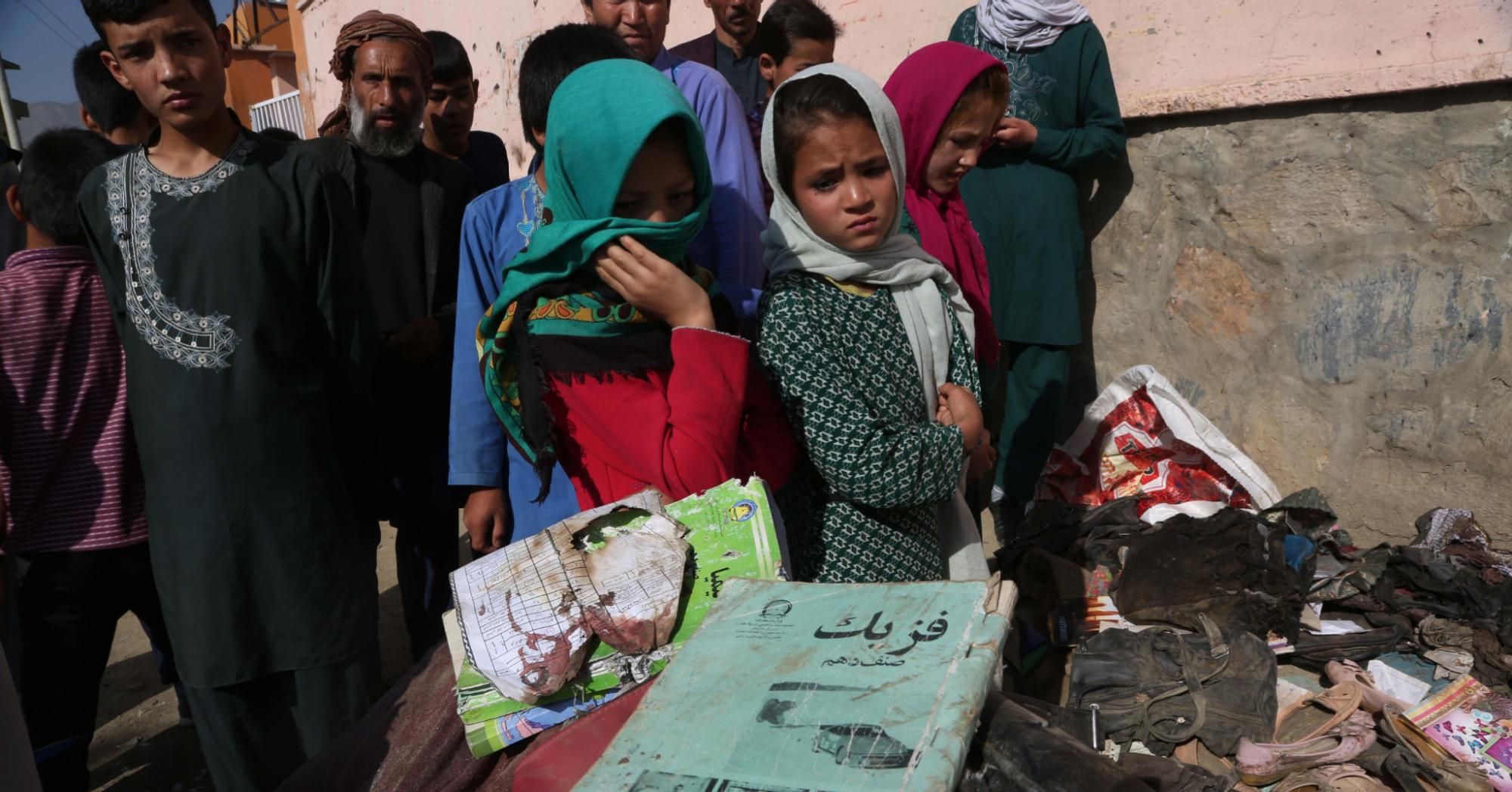 People look at the books of students who were killed in a car bomb attack outside a school in Kabul, capital of Afghanistan, on May 8, 2021. (Photo: Rahmatullah Alizadah/Xinhua via Getty Images)