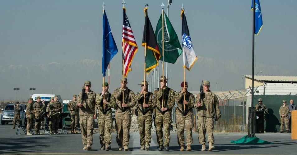 The ISAF color guard marches during the ISAF Joint Command (IJC) and XVIII Airborne Corps colors casing ceremony, Dec 8, 2014 at North Kabul Afghanistan International Airport, Afghanistan. Despite public ceremonies like this one, marking the supposed conclusion of U.S.-led combat, the war continues. (Photo: ISAF/Public Domain)