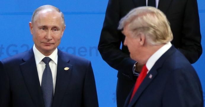 U.S. President Donald Trump (R) looks at Russian President Vladimir Putin (L) during the family photo at the G20 Summit's Plenary Meeting in Buenos Aires, Argentina, November, 30,2018.