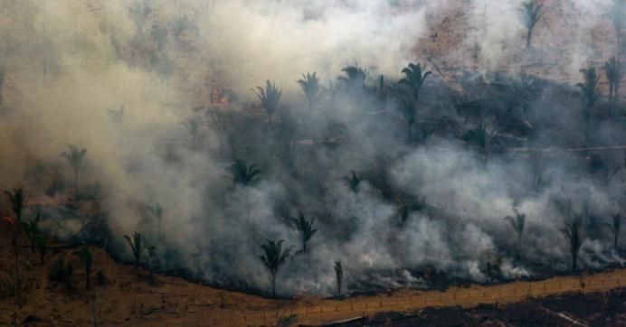 Aerial view showing smoke billowing from a patch of forest being cleared with fire in the surroundings of Boca do Acre, a city in Amazonas State, in the Amazon basin in northwestern Brazil, on August 24, 2019.