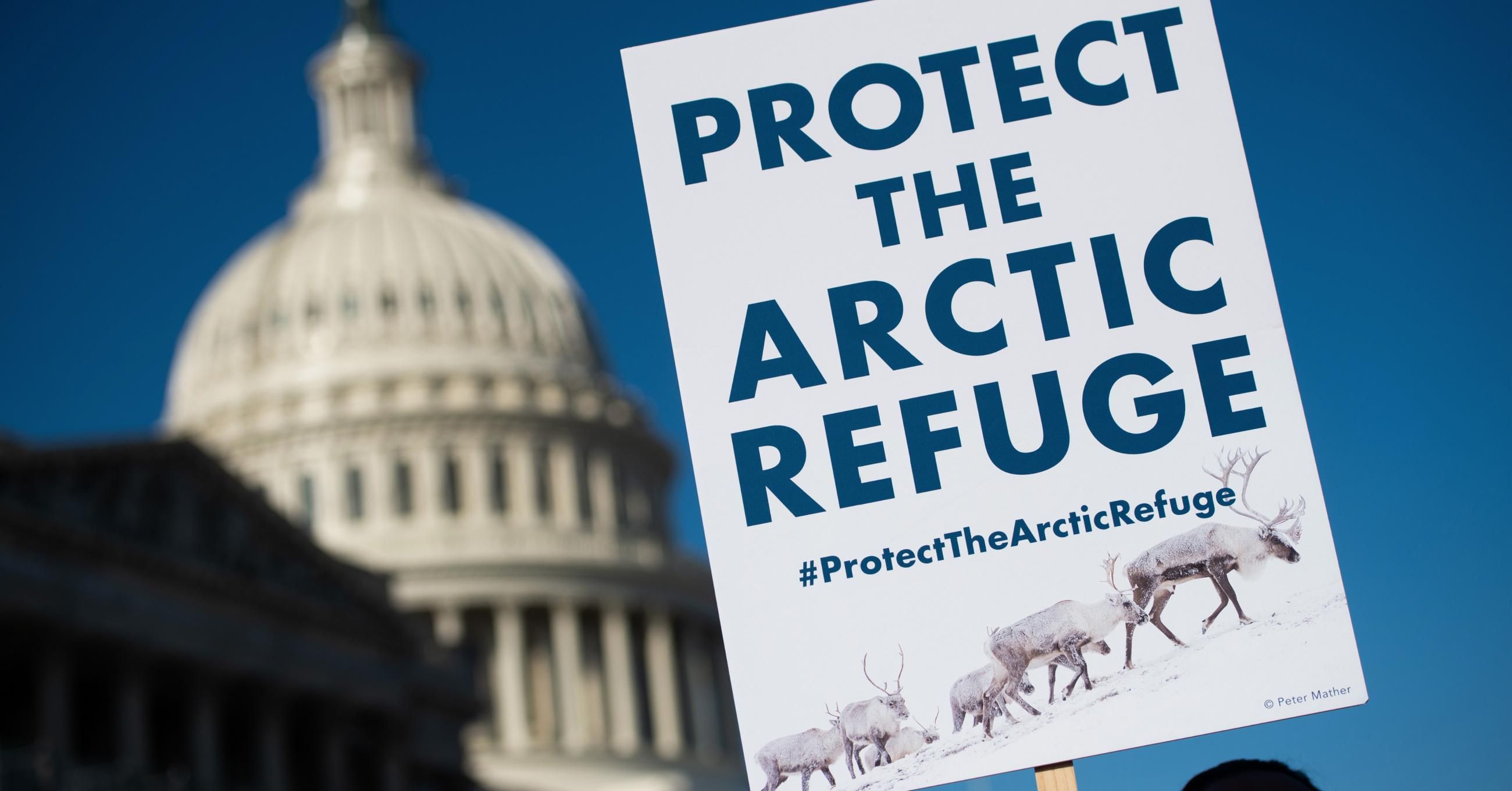 A demonstrator holds a sign against drilling in the Arctic National Wildlife Refuge during a press conference outside the U.S. Capitol in Washington, D.C., on December 11, 2018. (Photo: Saul Loeb//AFP via Getty Images)