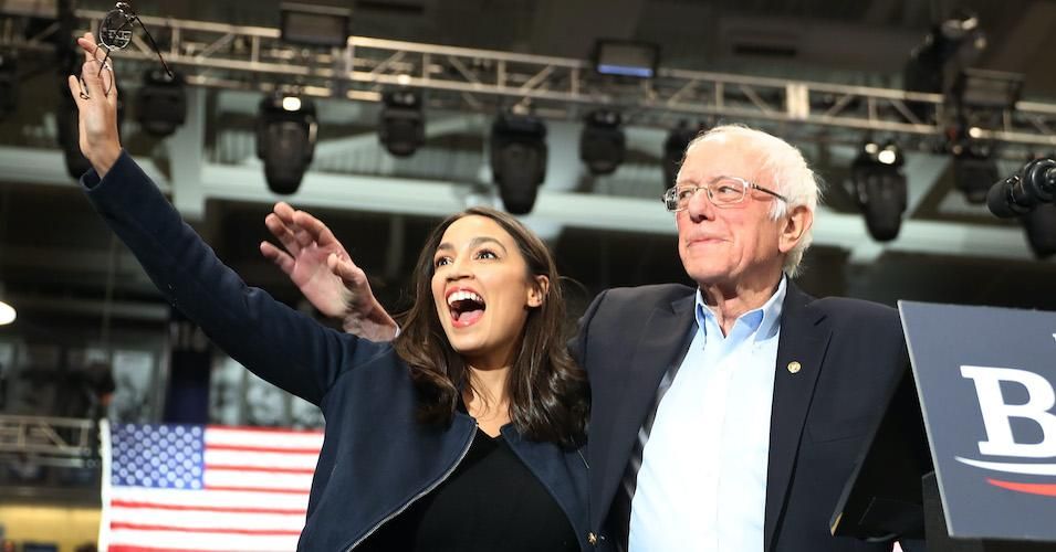 Rep. Alexandria Ocasio-Cortez (D-N.Y) and Democratic presidential candidate Sen. Bernie Sanders (I-Vt.) stand together during his campaign event at the Whittemore Center Arena on February 10, 2020 in Durham, New Hampshire.