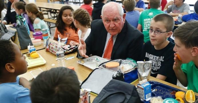 Perhaps explaining why he thinks nutrition guidelines are excessive, Agriculture Secretary Sonny Perdue dines with elementary school students in Leesburg, Virginia. (Photo: ABC News)