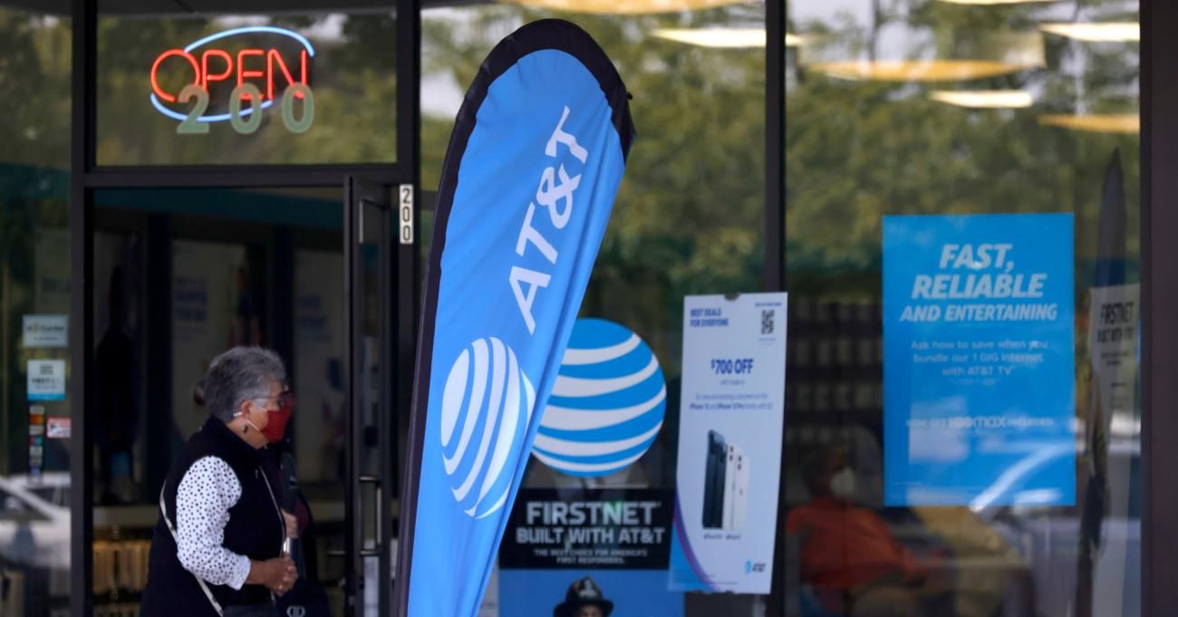 A pedestrian walks by an AT&T retail store on May 17, 2021 in San Rafael, California. AT&T, the world's largest telecommunications company, announced a deal with Discovery, Inc. which will spin off AT&T's WarnerMedia and be combined with Discovery to create a new standalone media company. (Photo: Justin Sullivan/Getty Images)