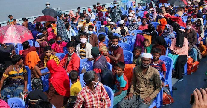 Rohingya refugees board a Bangladesh Navy ship to be transported to the island of Bhashan Char in Chittagong on December 4, 2020.