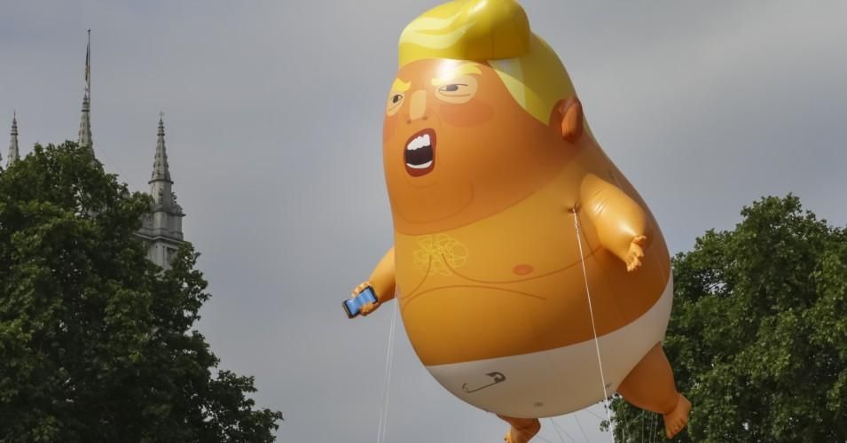 A giant baby trump balloon flies over the Parliament Square during a demonstration against the visit to the UK by US President Donald Trump on July 13, 2018 in London, England.