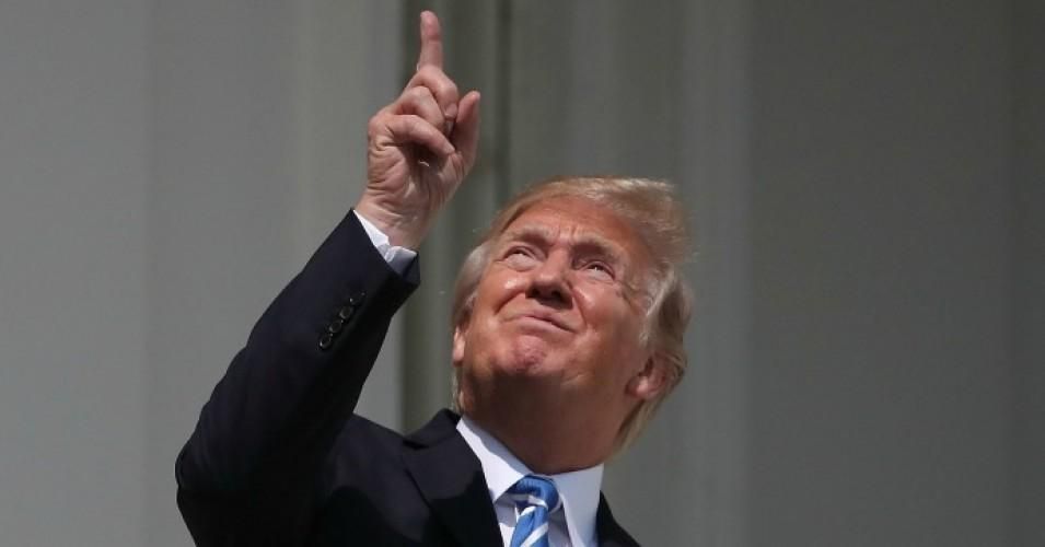 U.S. President Donald Trump looks up toward the Solar Eclipse on the Truman Balcony at the White House on August 21, 2017