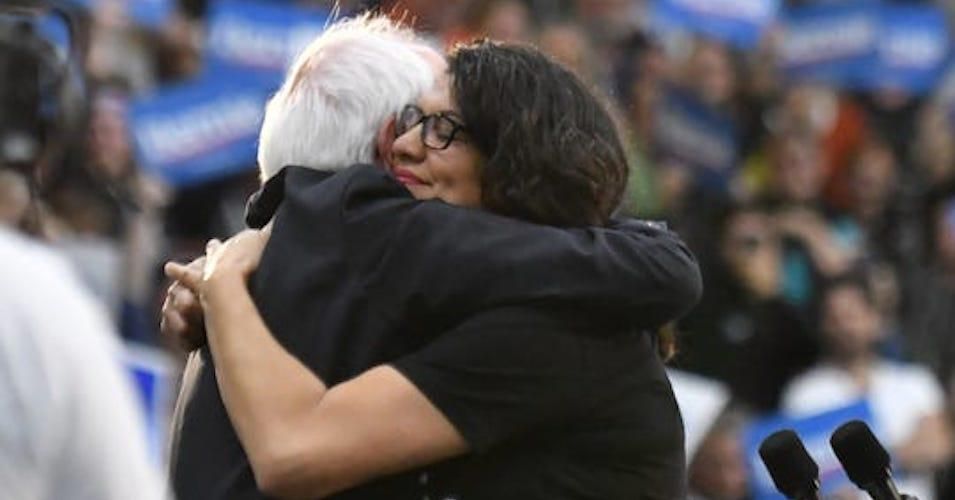 Rep. Rashida Tlaib hugs Sen. Bernie Sanders at a rally at Cass Tech High School in Detroit on Oct. 27, 2019. 