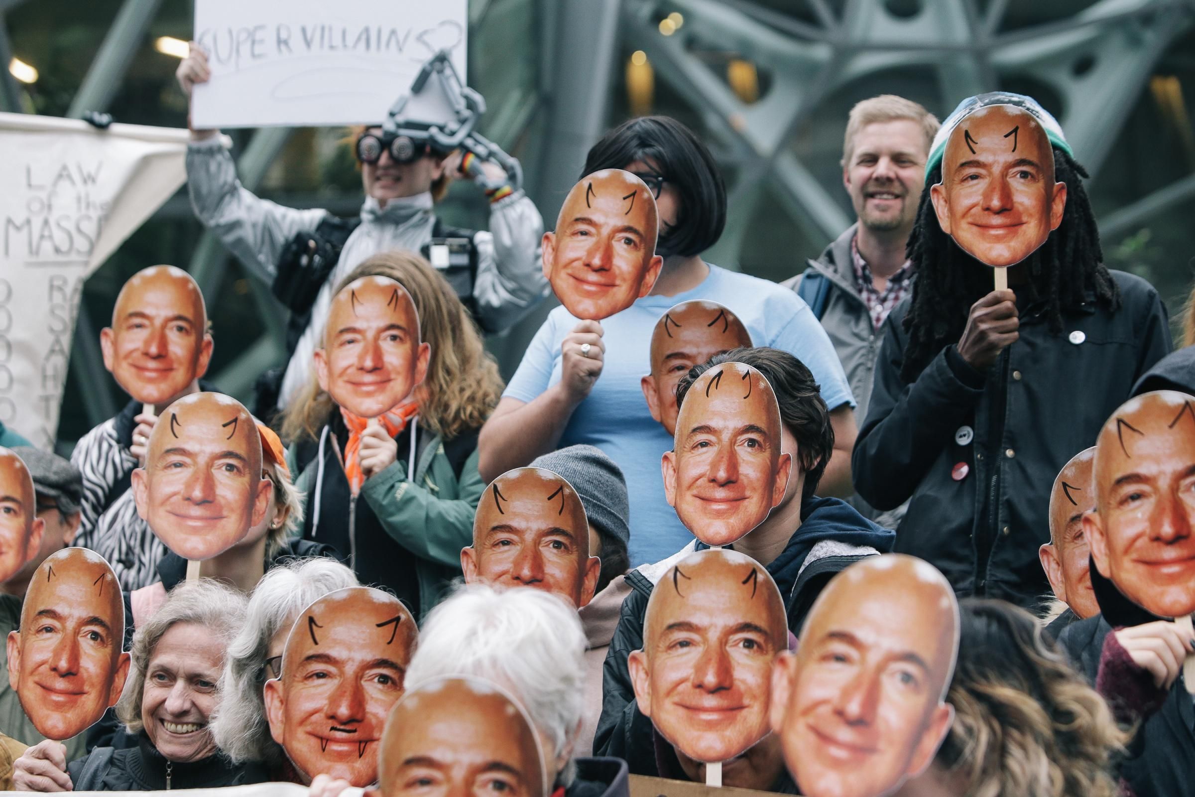 Several dozen protesters held up masks of Amazon CEO Jeff Bezos as they gathered in San Francisco on October 31, 2018 to denounce the company for providing its facial recognition software, Rekognition, to U.S. Immigration and Customs Enforcement. (Photo: Genna Martin/<em>San Francisco Chronicle</em> via Getty Images)