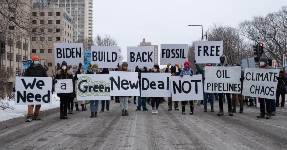 People hold signs calling for President Joe Biden to support a Green New Deal and end his support of pipelines and the fossil fuel industry in St. Paul on January 29, 2021. (Photo: Tim Evans/NurPhoto via Getty Images)