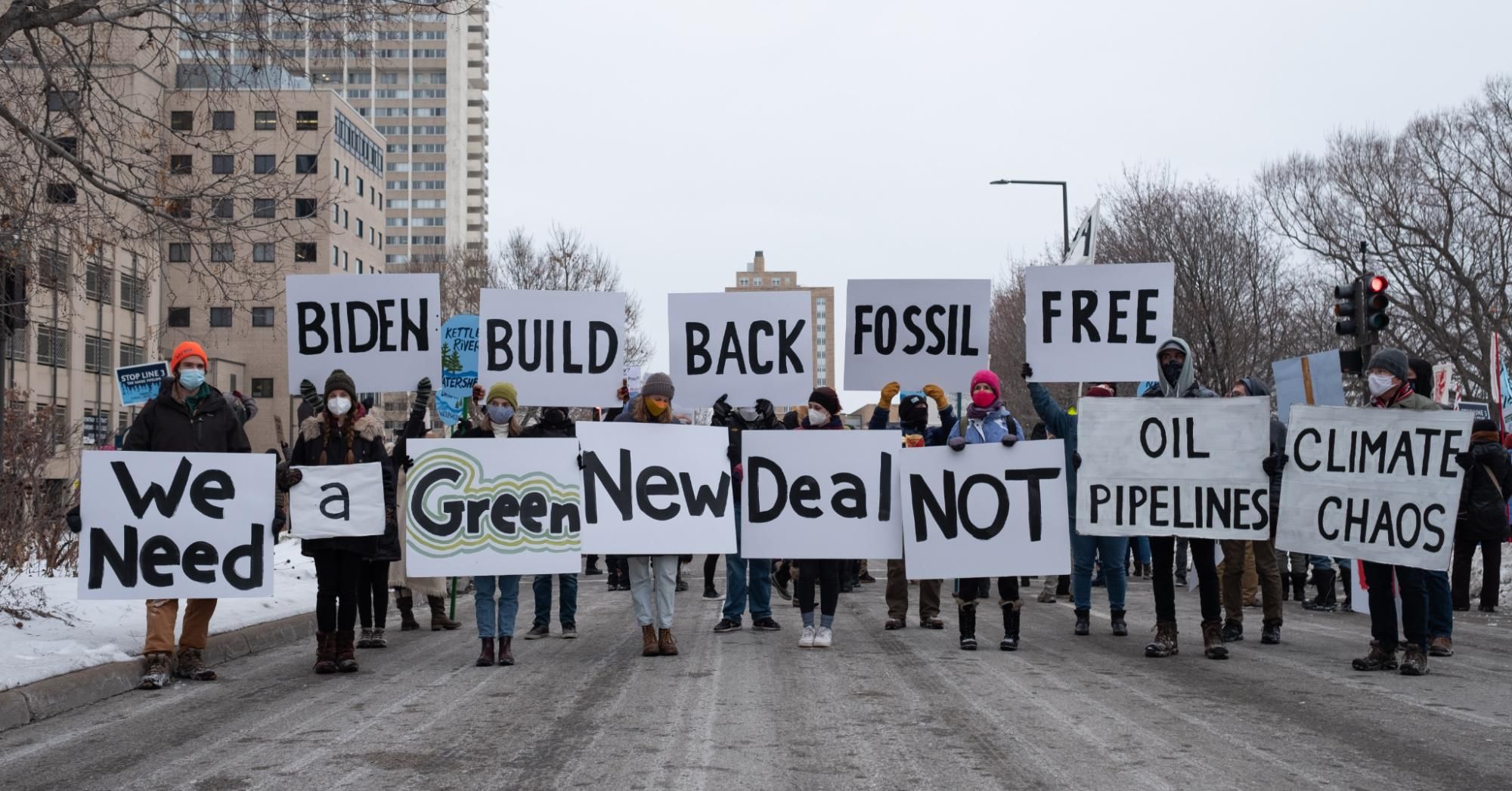 People hold signs calling for U.S. President Joe Biden to support a Green New Deal and end his support of pipelines and the fossil fuel industry in St. Paul on January 29, 2021. (Photo: Tim Evans/NurPhoto via Getty Images)
