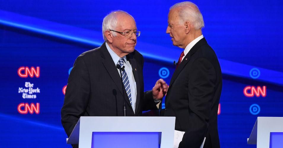 Democratic presidential hopefuls Vermont Sen. Bernie Sanders and former Vice President Joe Biden chat at the end of the fourth Democratic primary debate of the 2020 presidential campaign season co-hosted by The New York Times and CNN at Otterbein University in Westerville, Ohio on October 15, 2019.