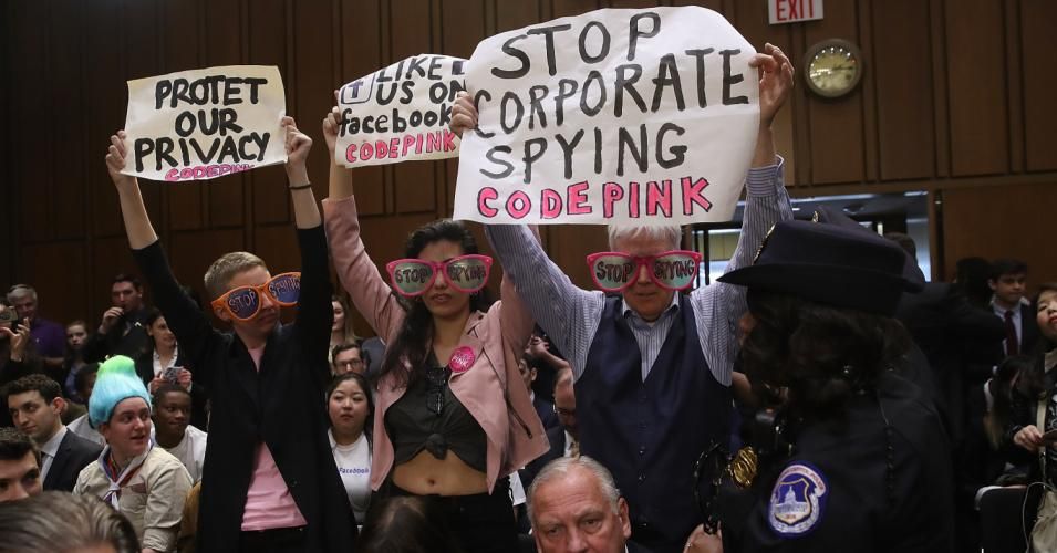 Protesters attend the hearing where Facebook co-founder and chief executive Mark Zuckerberg testified before a combined Senate Judiciary and Commerce committee hearing on April 10, 2018 in Washington, D.C. (Photo: Win McNamee/Getty Images)
