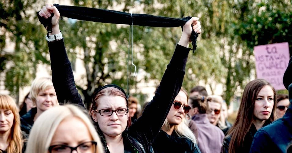 A protester holds up a coathanger at a demonstration against Poland's proposed near-total abortion ban.