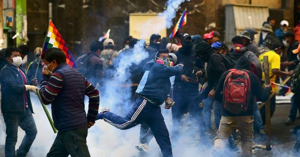 Supporters of Bolivian ex-president Evo Morales clash with riot police during a protest against the interim government in La Paz on November 15, 2019.