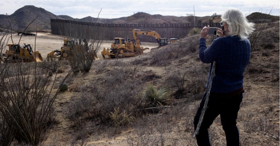 A border activist documents if construction along the new U.S.-Mexico border wall built under former President Donald Trump has halted approximately 15 miles east of Sasabe, Arizona on January 28, 2021 in the Coronado National Forest. (Photo: Andrew Lichtenstein/Corbis via Getty Images)