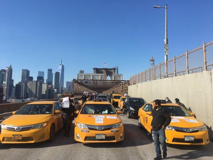 Taxi drivers block the Brooklyn Bridge on Wednesday, February 10, 2021. 