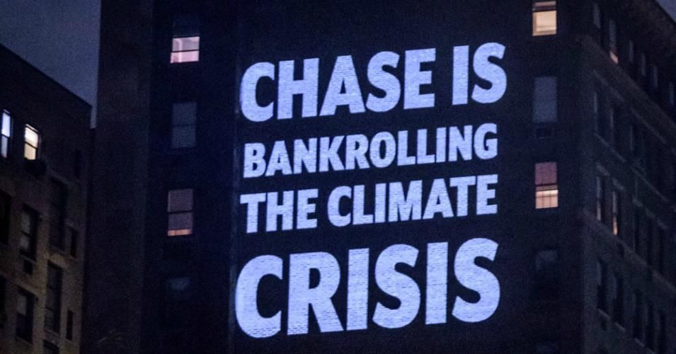 On the night before JPMorgan Chase's annual shareholders meeting, activists with Stop the Money Pipeline projected 30-foot-tall images of people holding protest signs with messages calling on CEO Jamie Dimon to "stop funding fossil fuels" on a wall across from his apartment in New York City. 