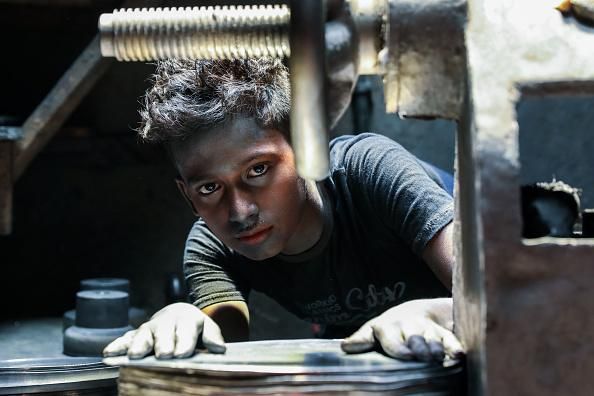 A twelve year-old works in a silver cooking pot factory in Dhaka, Bangladesh during the coronavirus crisis, which has led to a resurgence of child labor amid worsening economic deprivation and educational precarity. (Photo: Md Manik/SOPA Images/LightRocket via Getty Images)