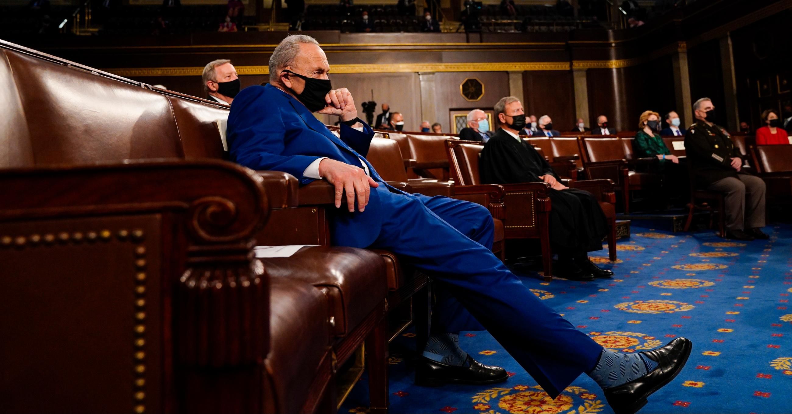 Senate Majority Leader Chuck Schumer (D-N.Y.) listens as President Joe Biden addresses a joint session of Congress at the U.S. Capitol on April 28, 2021.