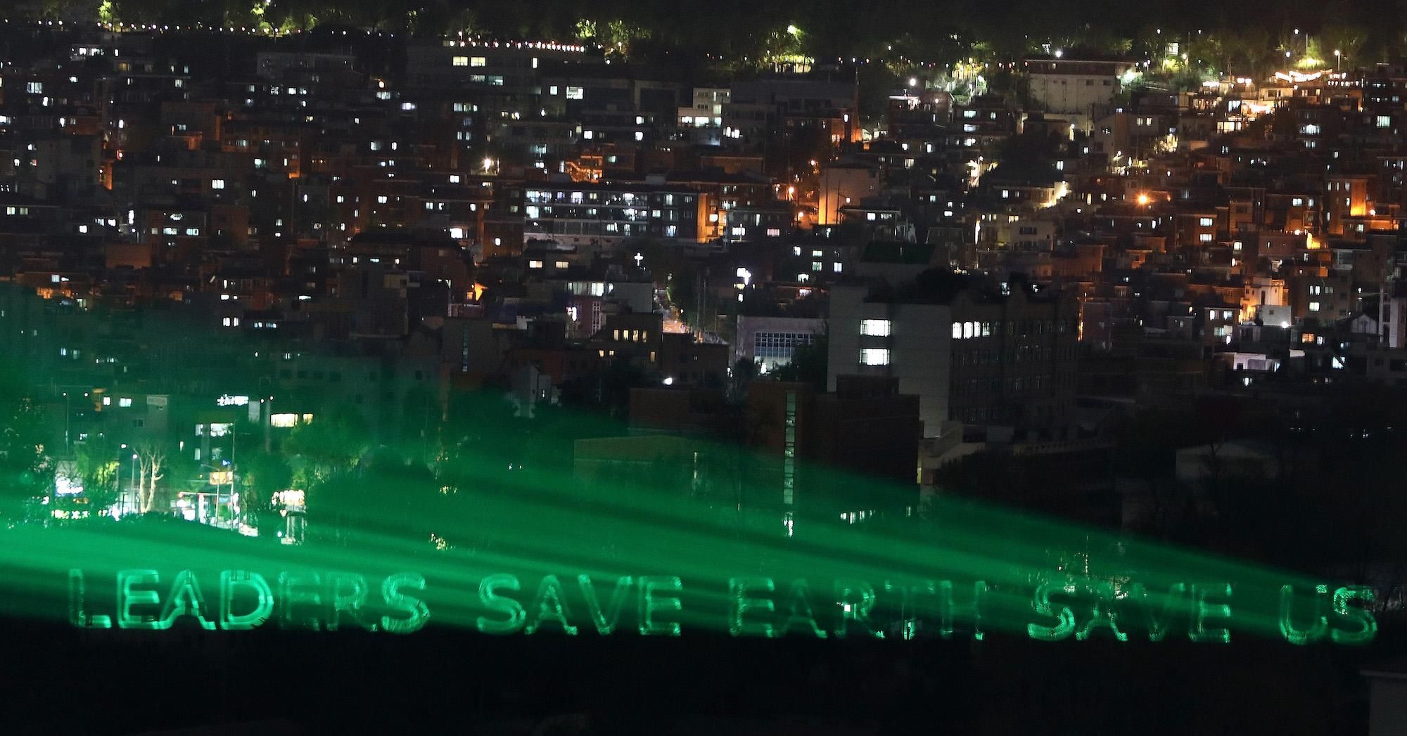 Greenpeace activists projected a message to world leaders to demanding urgent action to turn the tide on the worsening climate emergency on April 21, 2021 in Seoul, South Korea—the eve of U.S. President Joe Biden's Climate Leaders Summit. 