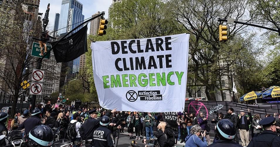 A banner is hung across a roadway while people participate in direct action with Extinction Rebellion on April 17, 2019 in New York City. 
