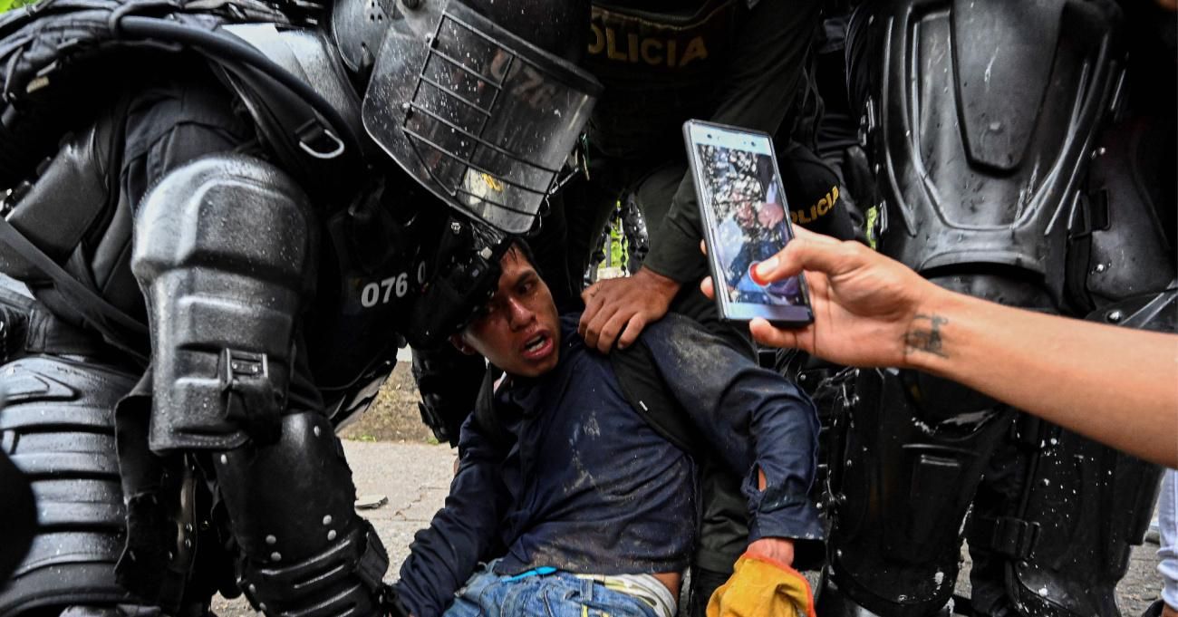 Colombian police officers arrest a demonstrator during a protest against the government in Cali, Colombia on May 10, 2021.
