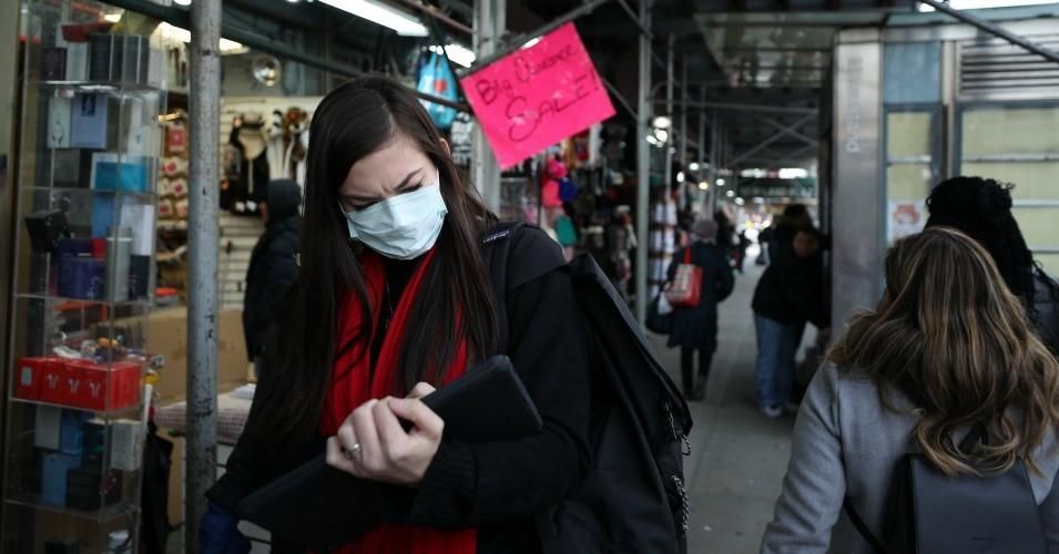 People wear medical masks amid the coronavirus outbreak, walking around the streets of New York on January 30, 2020. 