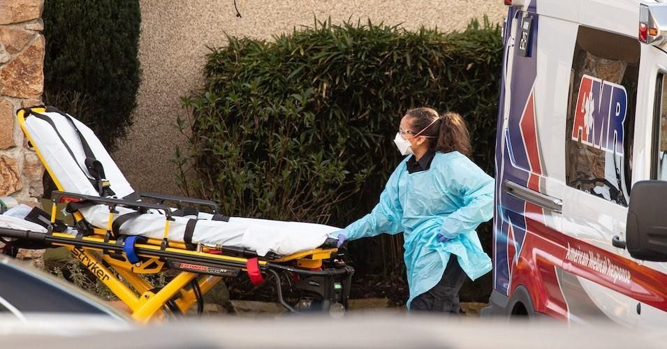 A healthcare worker prepares to transport a patient on a stretcher into an ambulance at Life Care Center of Kirkland on February 29, 2020 in Kirkland, Washington.
