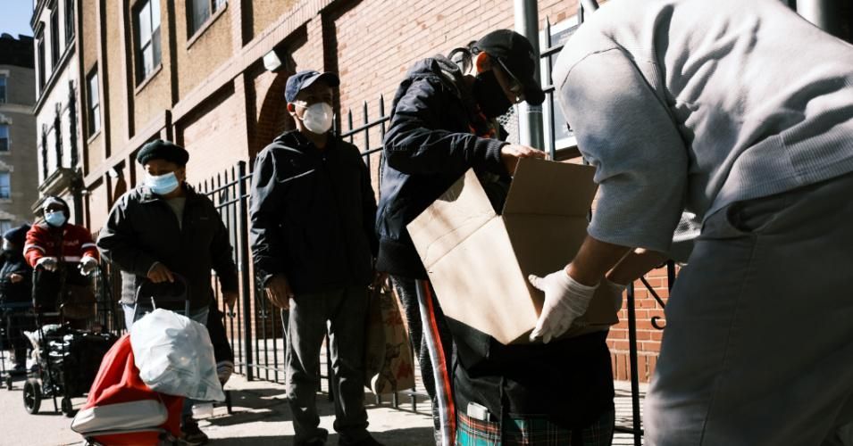 People receive food at Thessalonica Christian Church during a distribution on October 17, 2020 in New York City. (Photo: Spencer Platt/Getty Images)