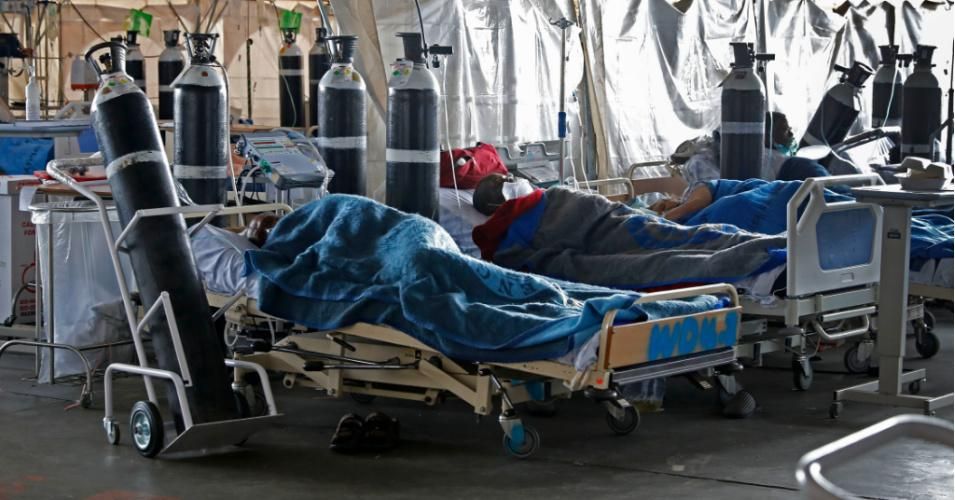 People are seen lying on hospital beds inside a temporary ward dedicated to the treatment of Covid-19 patients at Steve Biko Academic Hospital in Pretoria, South Africa on January 11, 2021. (Photo: Phill Magakoe/AFP via Getty Images)