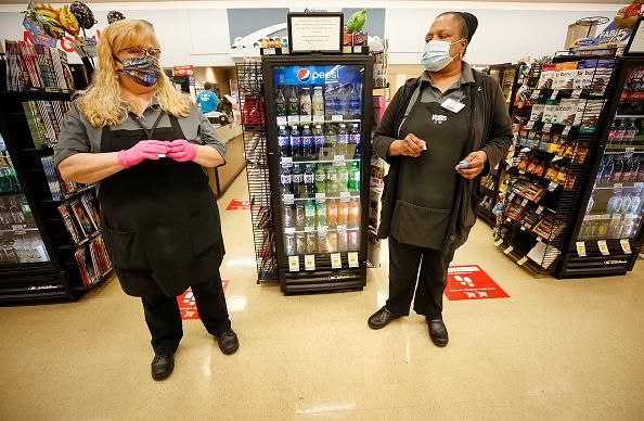 Grocery store cashiers took at moment to talk before customers were allowed in at 7 a.m. at a Vons located in Torrance, CA, on April 27, 2020. (Photo: Al Seib/Los Angeles Times via Getty Images)