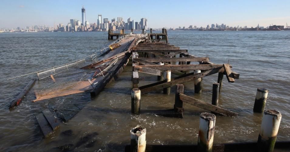 A dock sits damaged near the Statue of Liberty