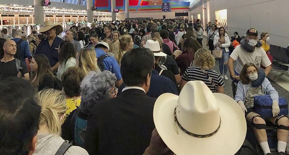 People wait in line to go through the customs at Dallas Fort Worth International Airport in Grapevine, Texas, Saturday, March 14, 2020