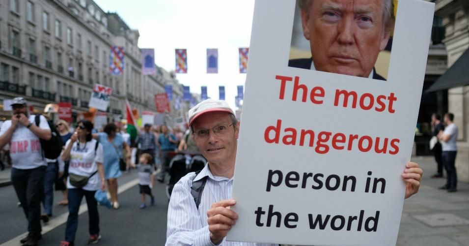 sign with photo of Trump reads 'the most dangerous in the world'