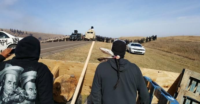 Indigenous water protectors face off with police during last week's military-style raid. (Photo: Wes Enzinna/cc/flickr)
