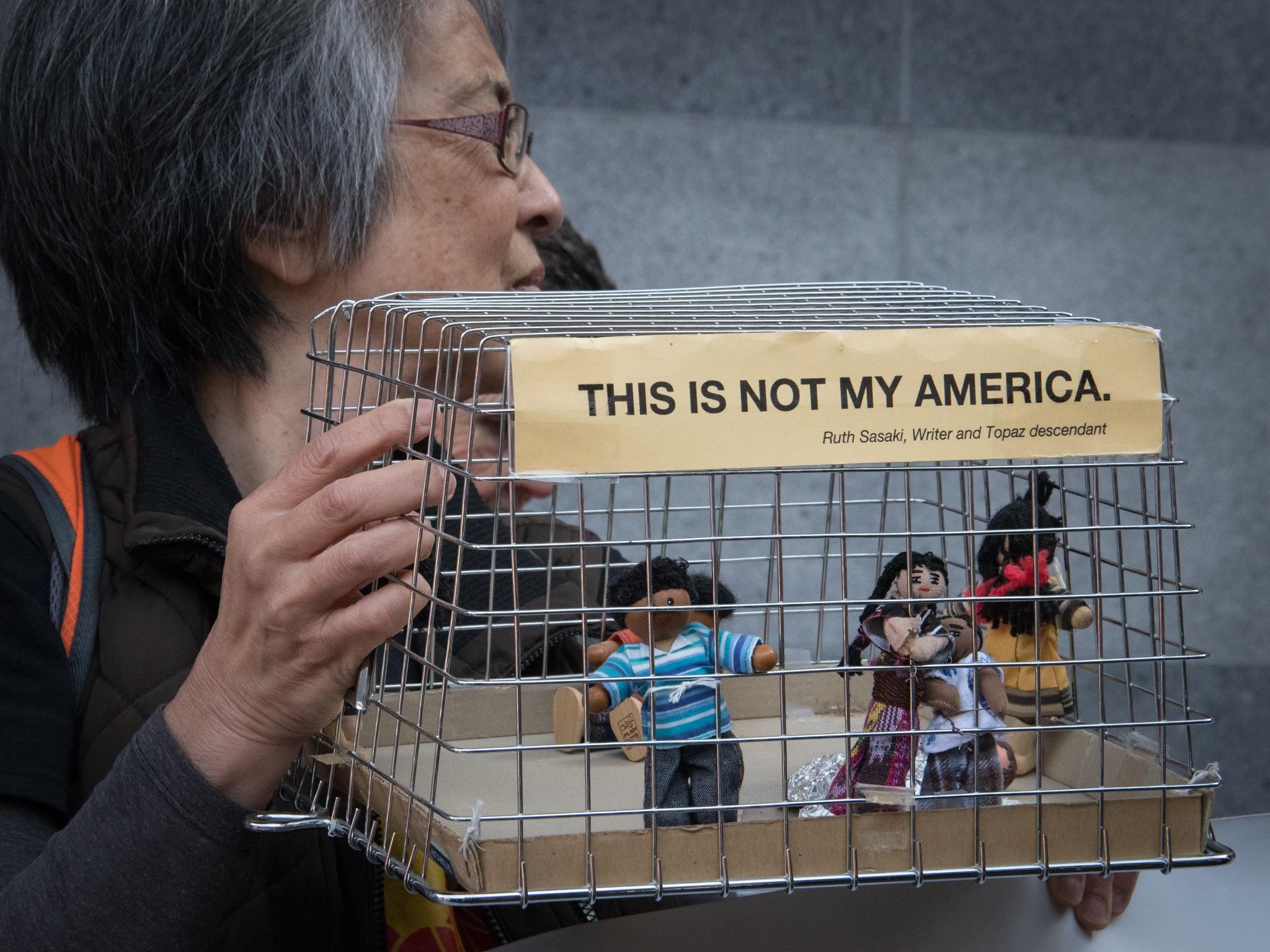 An activist holds a prop portraying incarcerated immigrants at a February 14, 2020 vigil outside the ICE building in San Francisco.