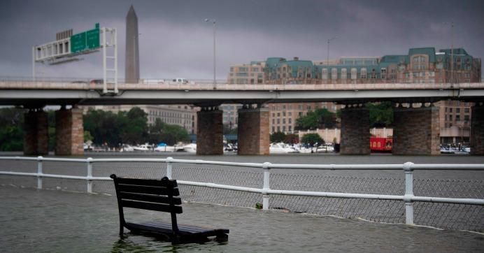 A park bench sits under water in East Potomac Park in Washington, D.C. on July 8, 2019, after a storm caused flooding. 