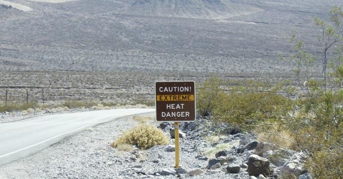 road sign in Death Valley reads "Caution! Exteme heat danger"