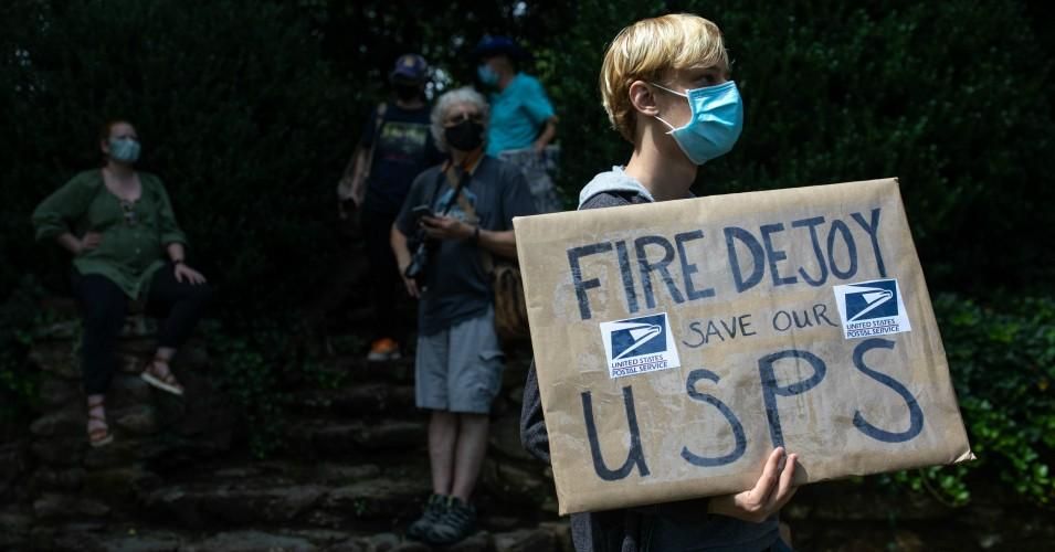 A group of protestors hold a demonstration in front of Postmaster General Louis DeJoy's home in Greensboro, North Carolina on August 16, 2020.
