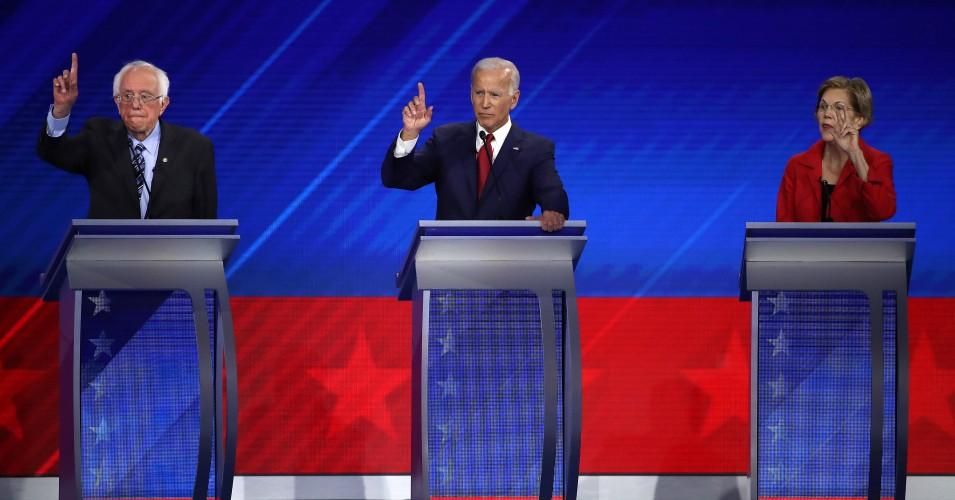 Democratic presidential candidates Sen. Bernie Sanders (I-VT), former Vice President Joe Biden, and Sen. Elizabeth Warren (D-MA) raise their hands during the Democratic Presidential Debate at Texas Southern University's Health and PE Center on September 12, 2019 in Houston, Texas. (Photo by Win McNamee/Getty Images)