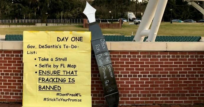 A placard from Floridians Against Fracking urges Florida's new governor, Ron DeSantis, to make good on his campaign promise to ban fracking in the state. 